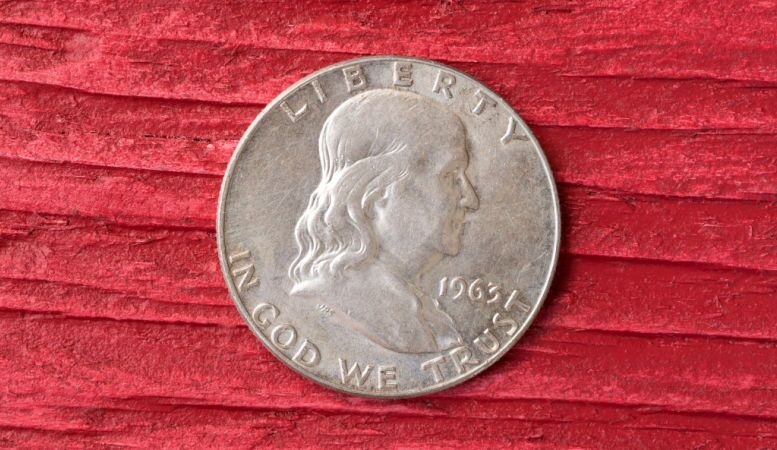 front view of an franklin half dollar coin on red background