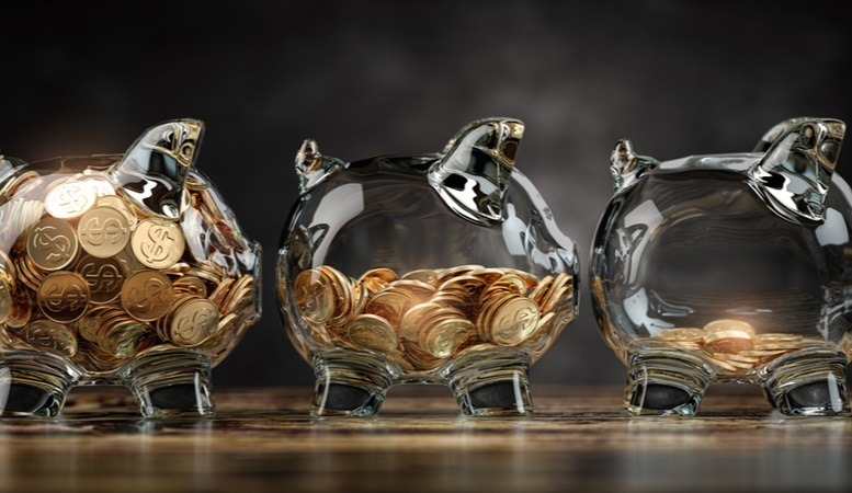glass piggy banks with decreasing pile of coins