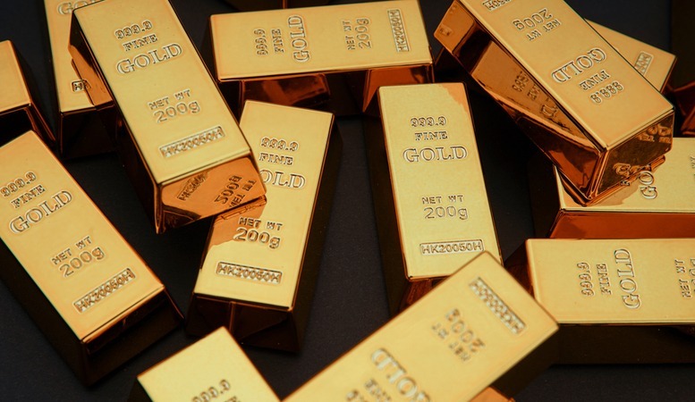 gold bars in a dark table