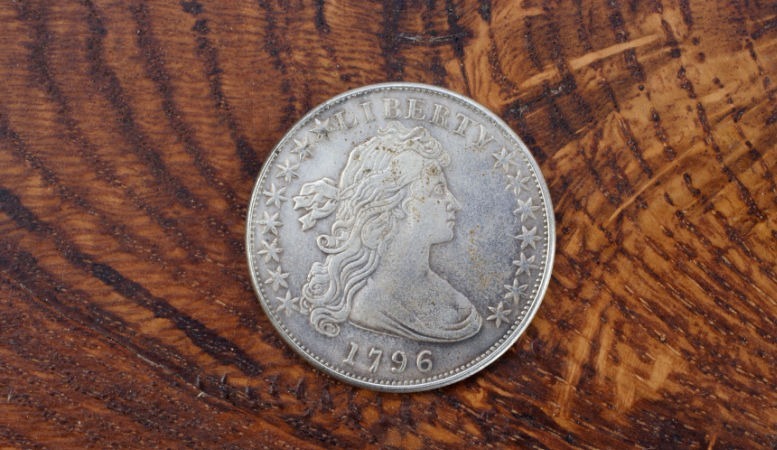 1796 drapped bust dime on wooden table