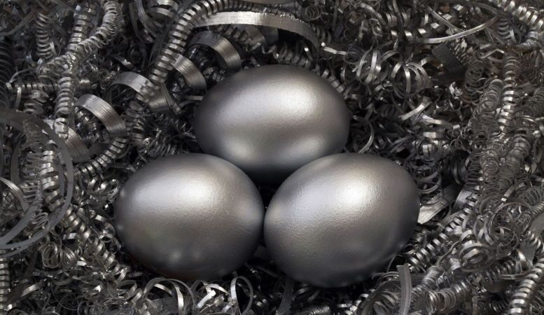 three silver eggs in a nest of silver metal shavings