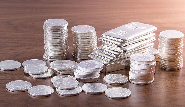 stack of silver bars and silver coins
