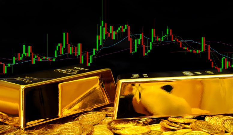 gold bars on pile of gold coins with gold chart in the background