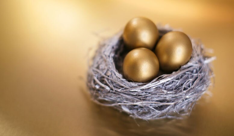 golden eggs and nest on gold background