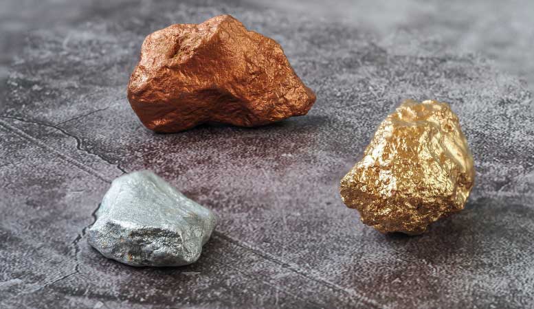 silver gold and bronze nuggets on surface
