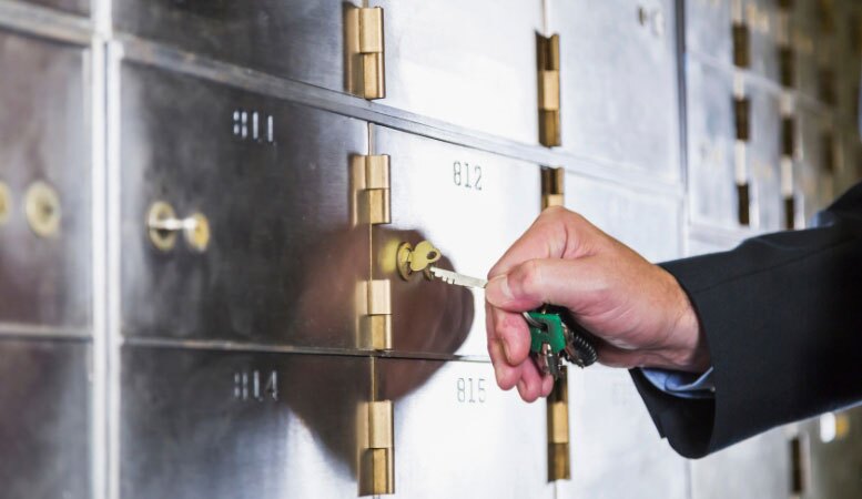 custodian unlocking safety deposit box