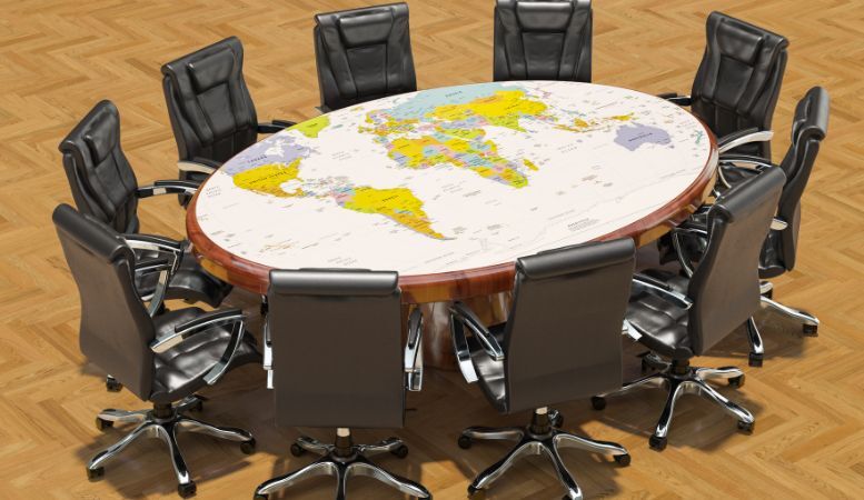 chairs and round table with political map