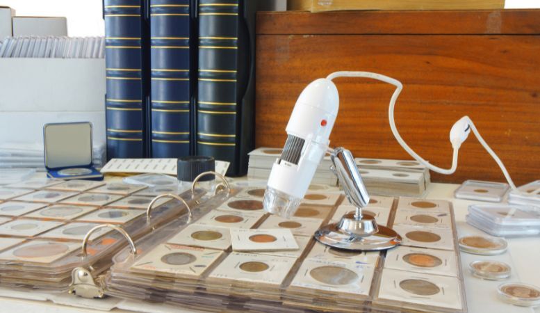 digital microscope on album with commemorative coins