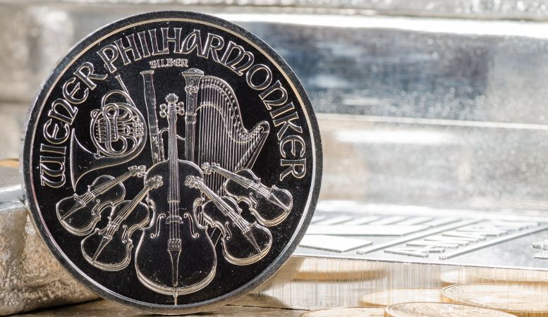 austrian philharmonic silver coin with silver bars and gold coins