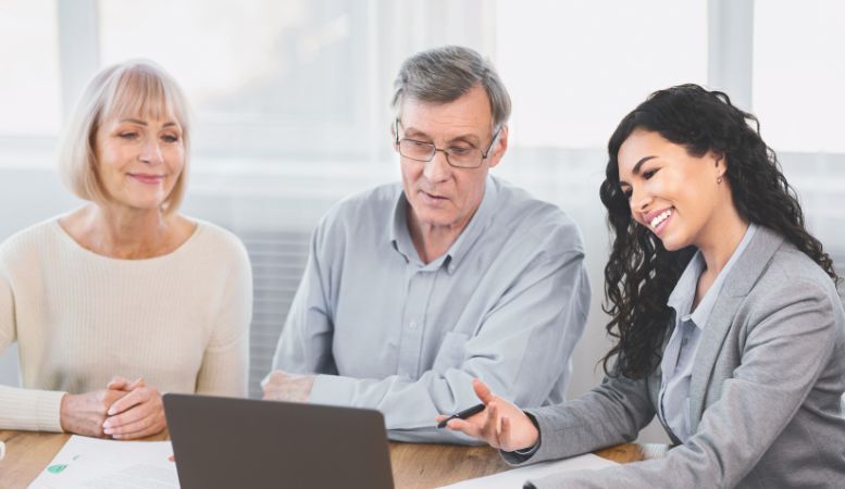 elderly couple consulting with financial advisor at home
