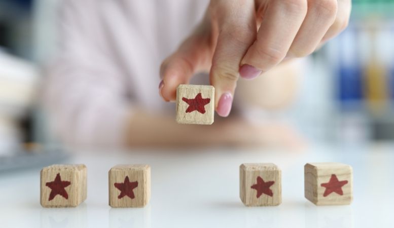 woman picking wooden cube with star icon