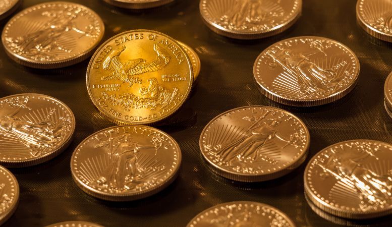 one ounce liberty gold eagle coins on table