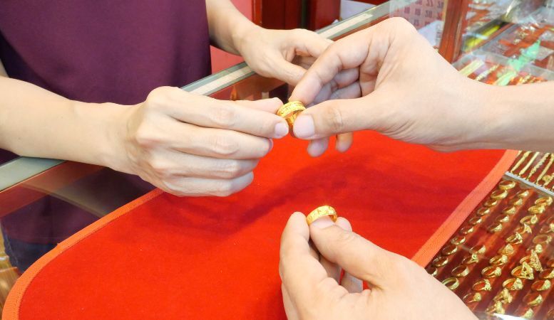 woman buying gold filled ring for her and her husband