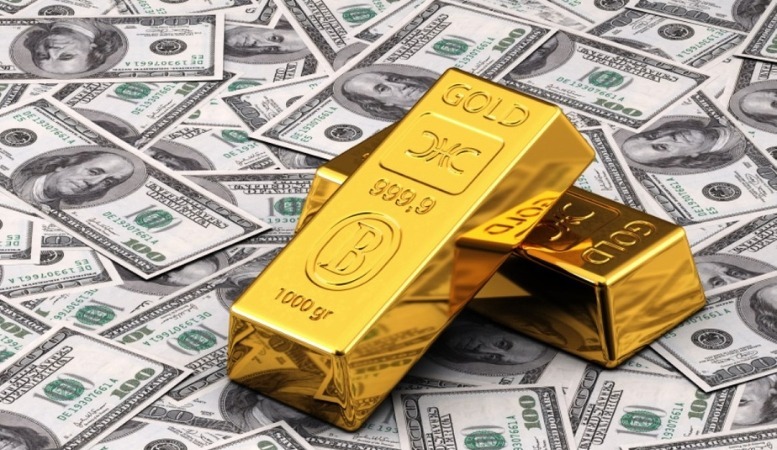 gold bars on money symbolizing its power over the dollar