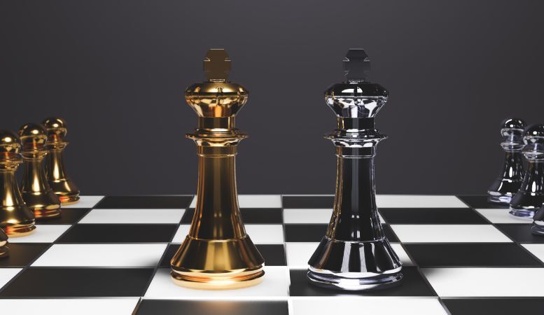 chessboard with gold and silver chess pieces
