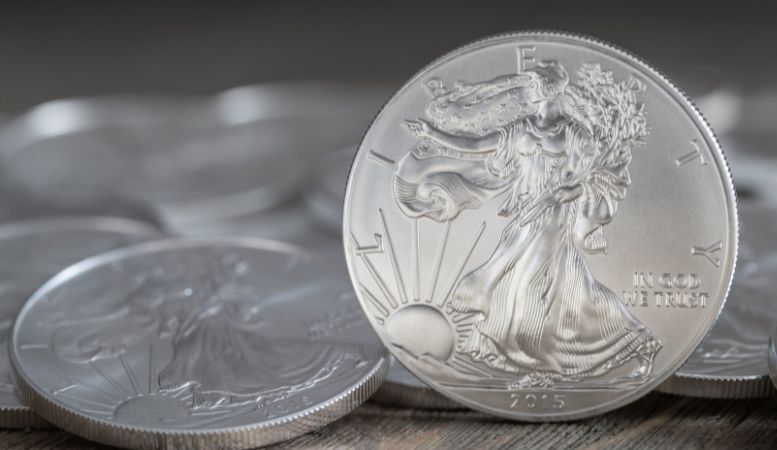 two American silver eagle coin on silver coins background