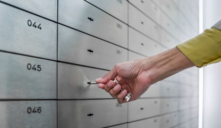 bank clerk opening safe deposit box
